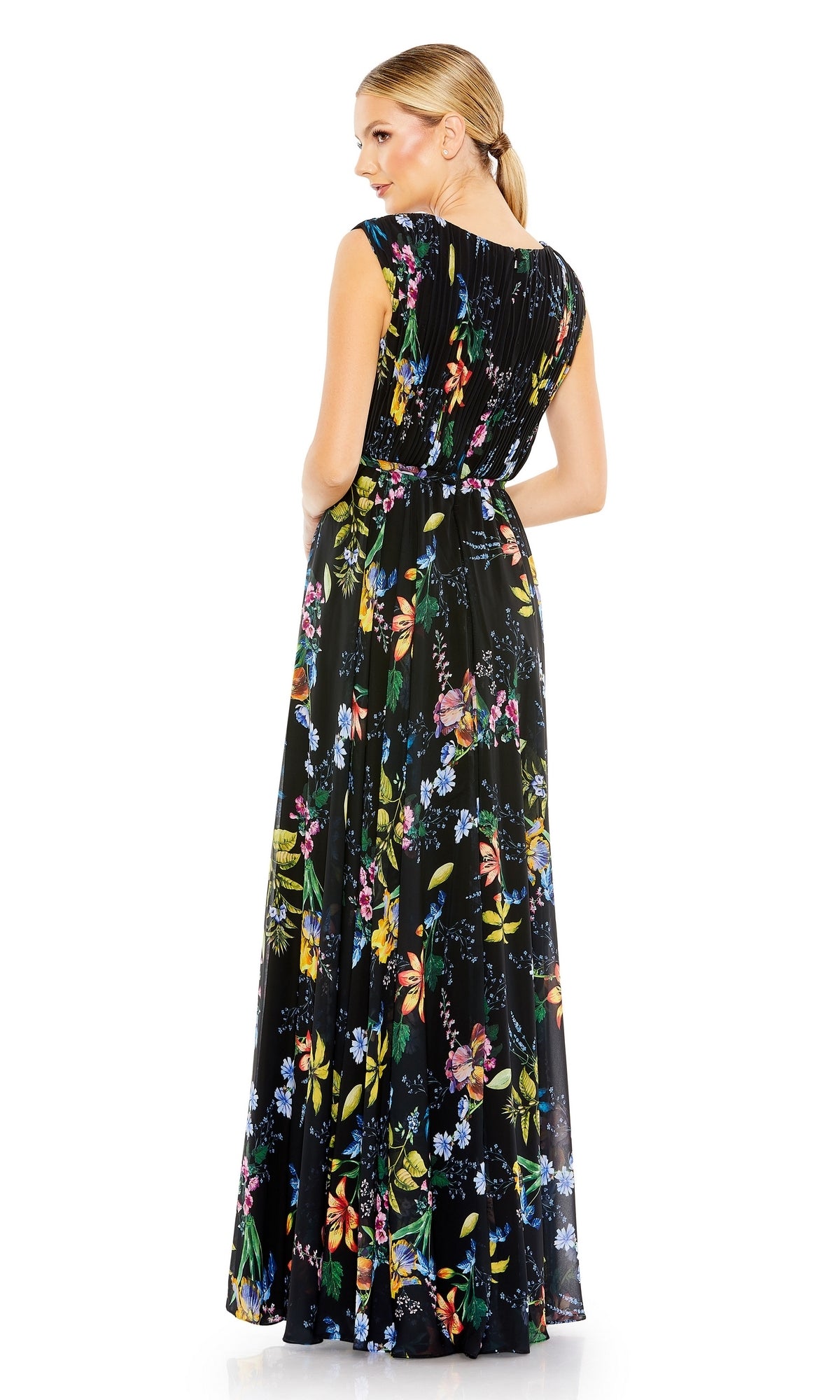 A woman faces away, wearing the Mac Duggal 55829 Long Floral-Print Formal Dress—black, sleeveless, and adorned with colorful florals.